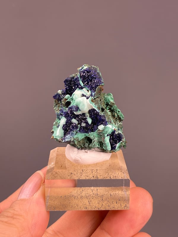 Azurite from Anhui, China: front view showing pale green areas between blue clusters.