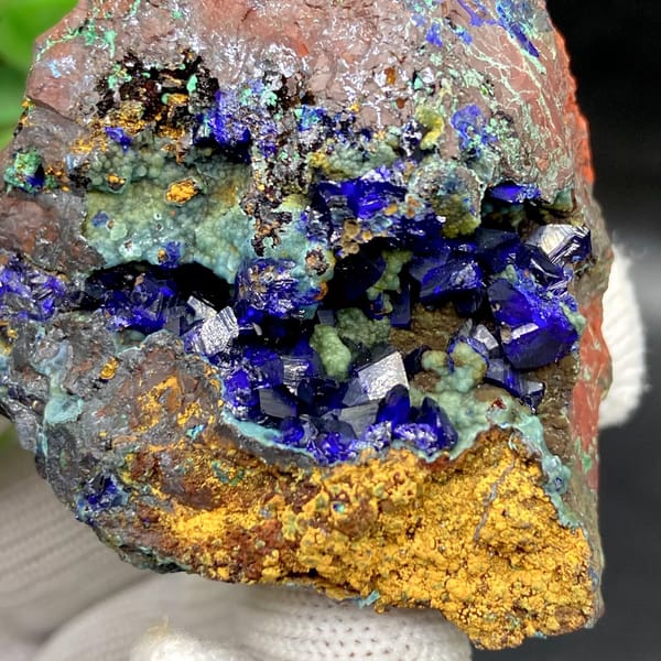 Deep blue azurite crystals with malachite and orange limonite from Anhui, China, view 3 of 9