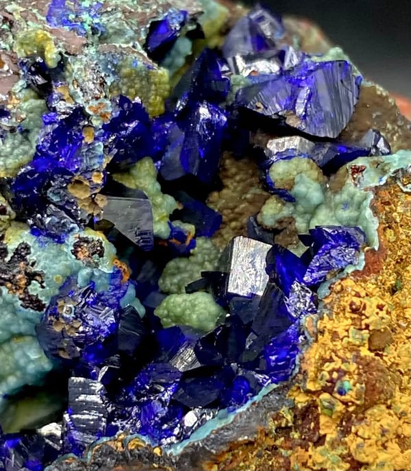 Deep blue azurite crystals with malachite and orange limonite from Anhui, China, view 8 of 9