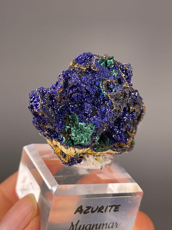 Azurite specimen from Myanmar presenting royal-blue crystals with green patches
