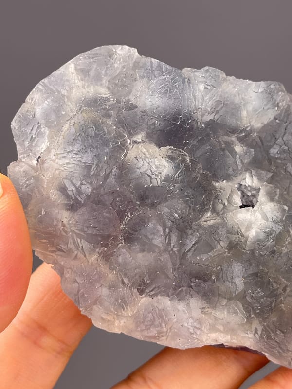 Bi-color Fluorite specimen from Zhejiang, China presenting gray-lilac aggregates with pale coating