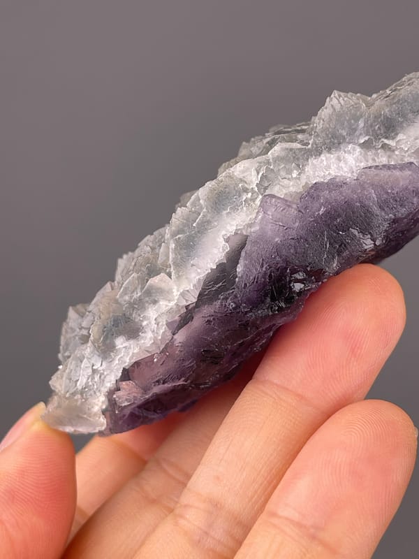 Gray-lilac aggregates with pale coating on natural bi-color fluorite specimen from Zhejiang, China