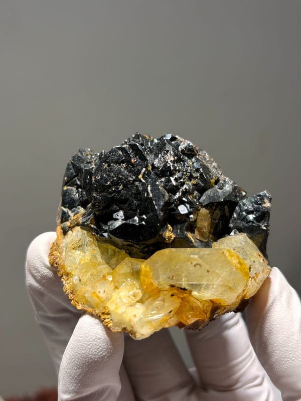 Black cassiterite plate with yellow aquamarine from Xuebaoding, Sichuan, China, second angle
