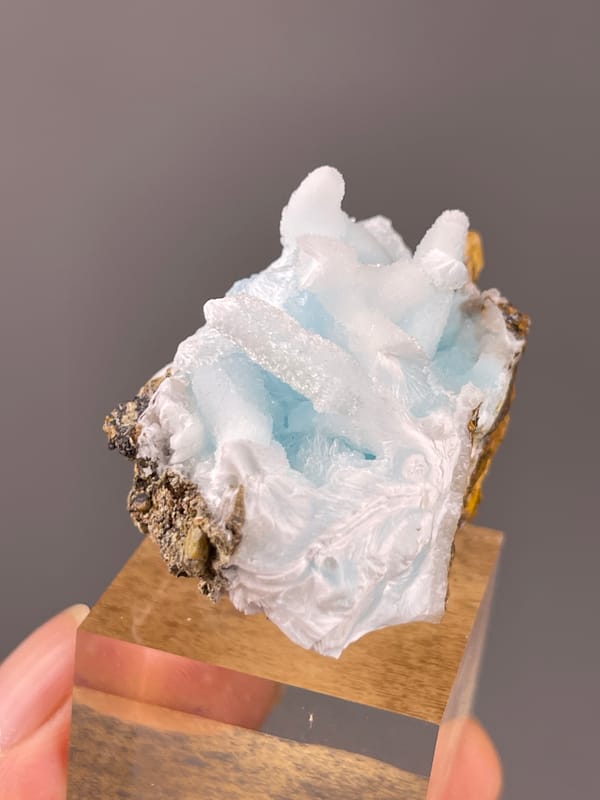 Blue Aragonite specimen from Yunnan, China presenting blue botryoidal base with white blades
