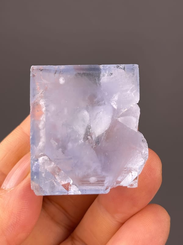 Blue Fluorite specimen displaying pale-blue cleavage-modified faces prominently