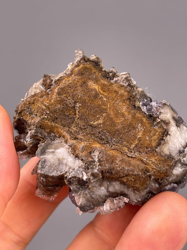 Pale Purple Fluorite specimen characterized by pale-purple cubes on brown blades visibly