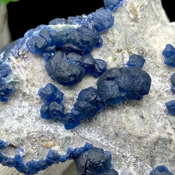 Navy-blue strawberry quartz balls and blue fluorite on pale plate from Inner Mongolia, China, view 4 of 9