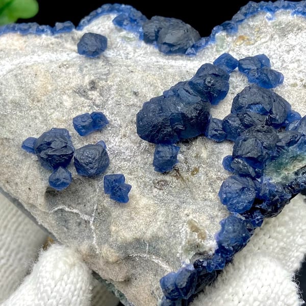 Navy-blue strawberry quartz balls and blue fluorite on pale plate from Inner Mongolia, China, view 6 of 9