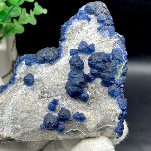 Navy-blue strawberry quartz balls and blue fluorite on pale plate from Inner Mongolia, China, view 7 of 9
