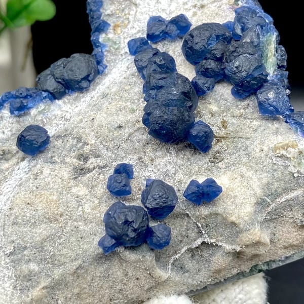 Navy-blue strawberry quartz balls and blue fluorite on pale plate from Inner Mongolia, China, view 8 of 9