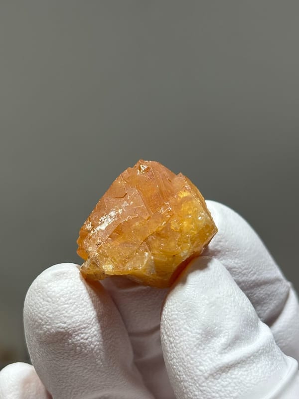 Bright orange scheelite crystal from Xuebaoding, Sichuan, China, view 3 of 5