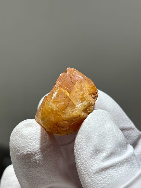 Bright orange scheelite crystal from Xuebaoding, Sichuan, China, view 4 of 5