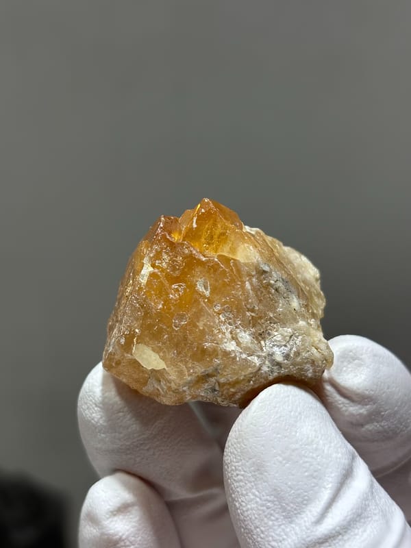 Bright orange scheelite crystal with floater base from Xuebaoding, Sichuan, China, second angle