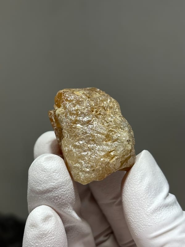 Bright orange scheelite crystal with floater base from Xuebaoding, Sichuan, China, reverse side