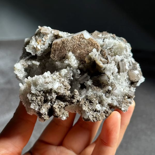 Brown hexagonal calcite plate on grey quartz from Fujian, China
