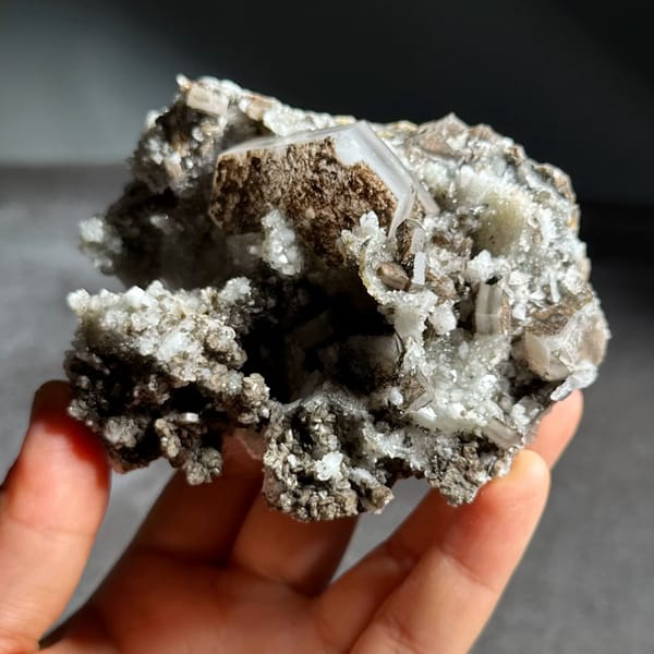 Brown hexagonal calcite plate on grey quartz from Fujian, China, view 2 of 12