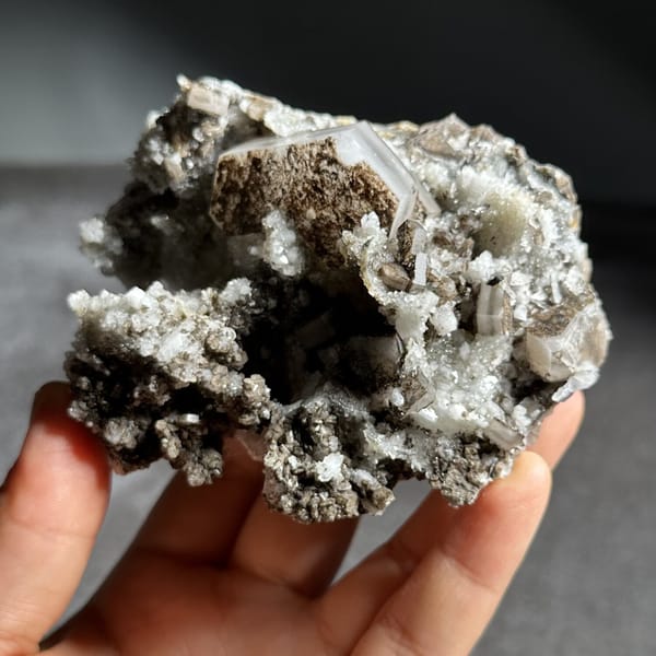 Brown hexagonal calcite plate on grey quartz from Fujian, China, view 8 of 12