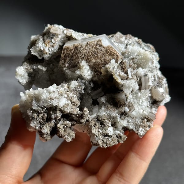 Brown hexagonal calcite plate on grey quartz from Fujian, China, view 9 of 12