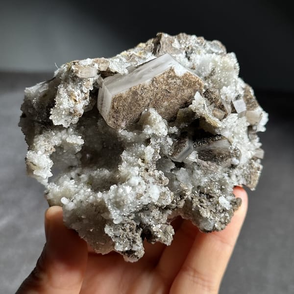 Brown hexagonal calcite plate on grey quartz from Fujian, China, view 10 of 12