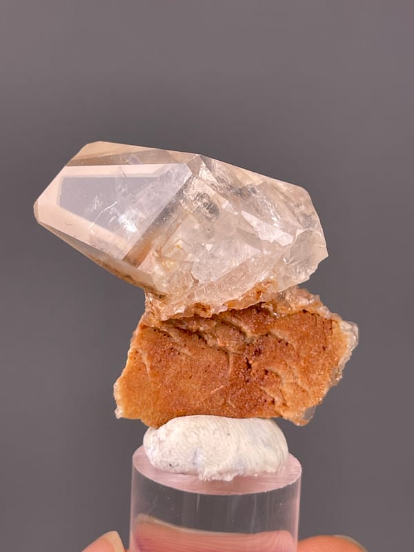 Calcite specimen from Daye, Hubei, China featuring clear prismatic crystal on brown matrix