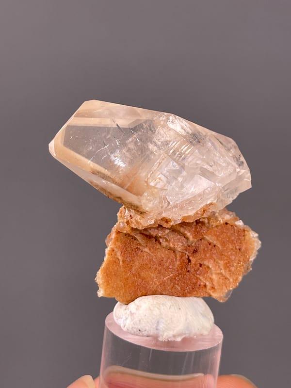 Calcite specimen from Daye, Hubei, China showing clear prismatic crystal on brown matrix