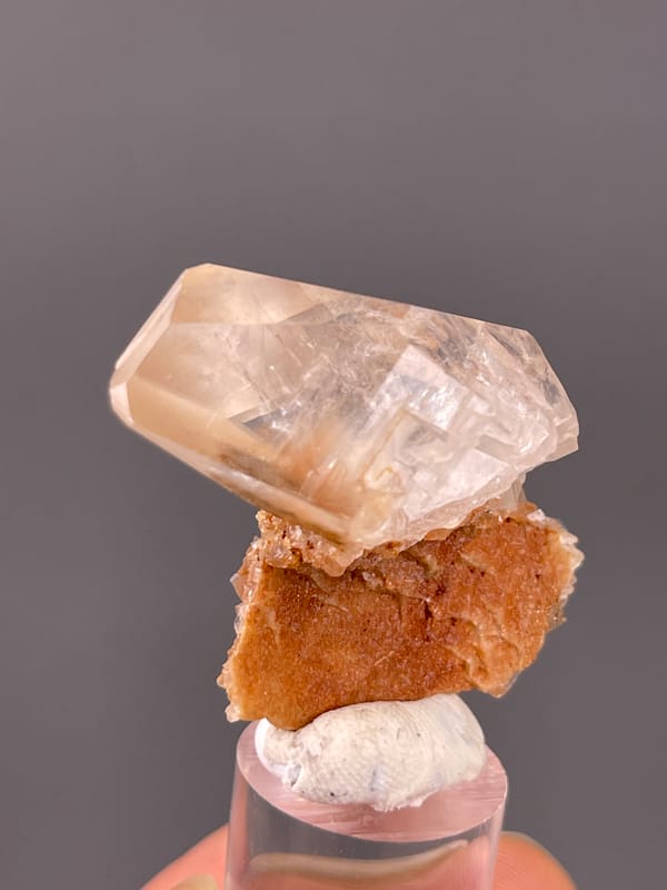 Calcite specimen from Daye, Hubei, China presenting clear prismatic crystal on brown matrix