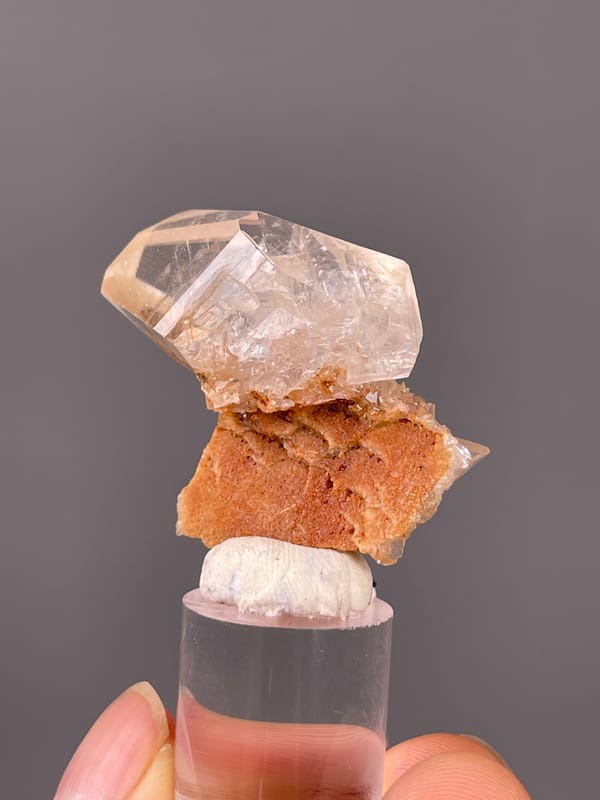 Calcite specimen from Daye, Hubei, China displaying clear prismatic crystal on brown matrix