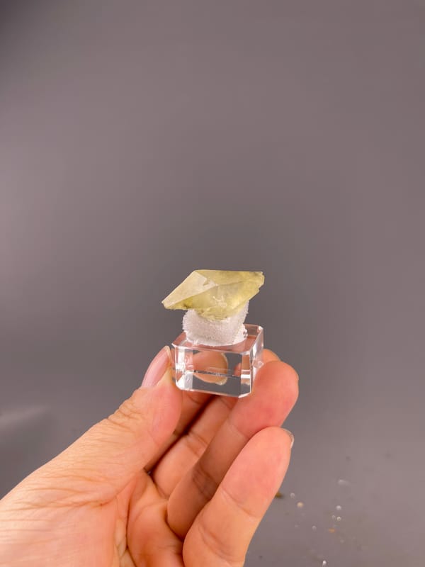 Calcite from Daye, Hubei, China: whole pale yellow crystal on its display base.