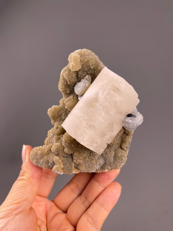 Calcite from Fujian, China: diagonal block against textured matrix.