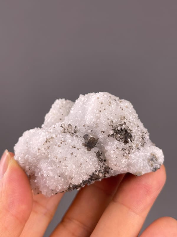 Calcite from Fujian, China: broad white quartz surface with brown crystal patches.