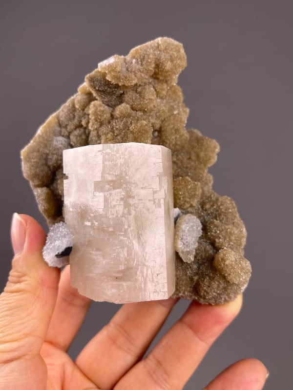 Calcite from Fujian, China: upright crystal with patchy surface markings.