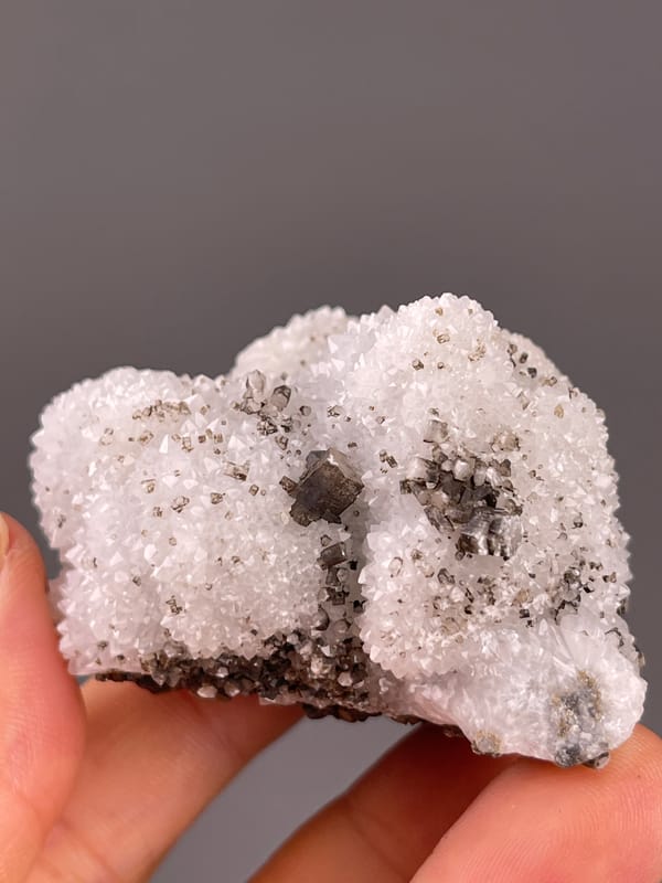 Calcite from Fujian, China: front view of the white quartz-covered matrix.
