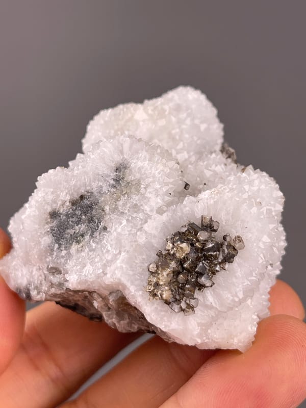 Calcite from Fujian, China: top angle showing brown crystals inside white recesses.