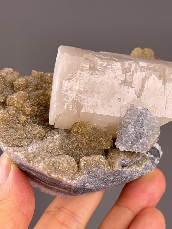 Calcite from Fujian, China: lower edge beside white crystalline clusters.