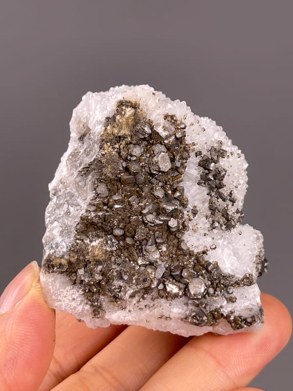 Calcite from Fujian, China: whole brown crystal group above the palm.