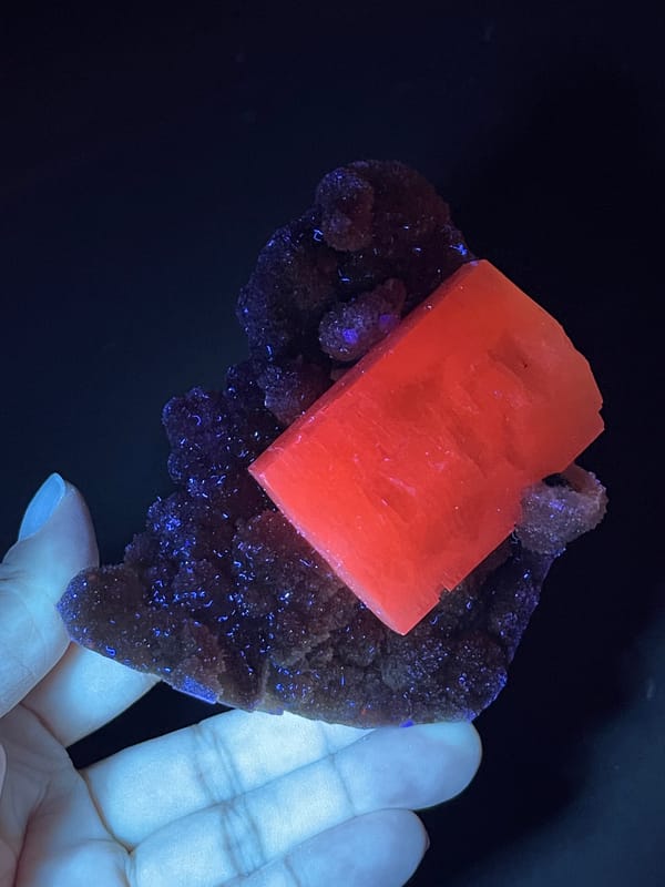 Calcite from Fujian, China: orange-red fluorescence in dark lighting.