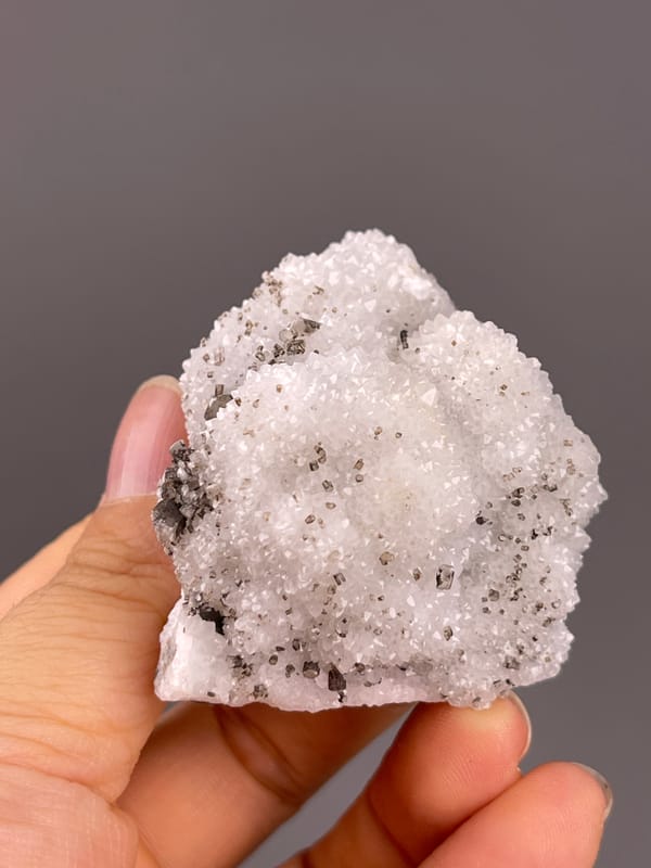 Calcite from Fujian, China: rounded reverse with fine white quartz crystals.