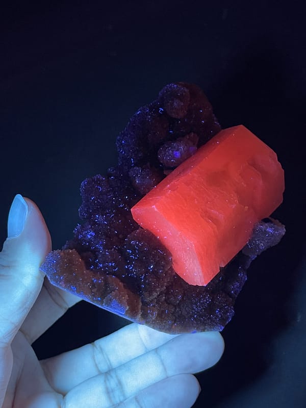 Calcite from Fujian, China: fluorescent crystal with brown matrix silhouette.