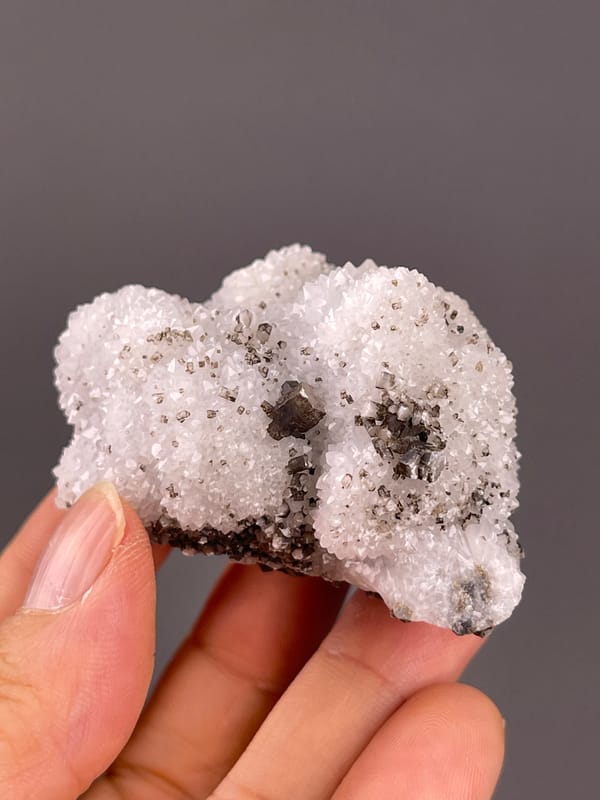 Calcite from Fujian, China: white quartz field surrounding isolated brown crystals.