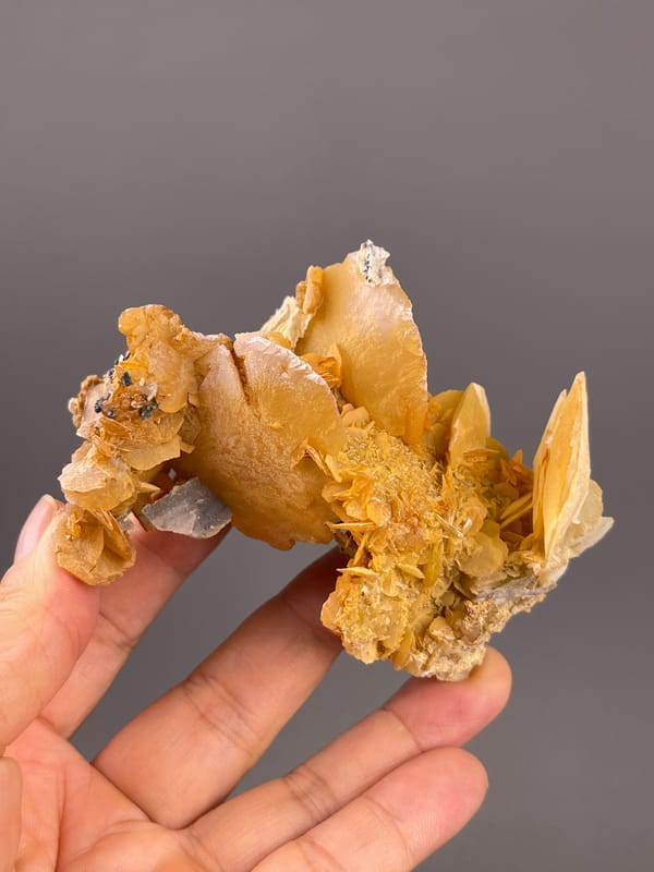 Calcite from Guangdong, China: broad yellow blade extending over smaller plates.