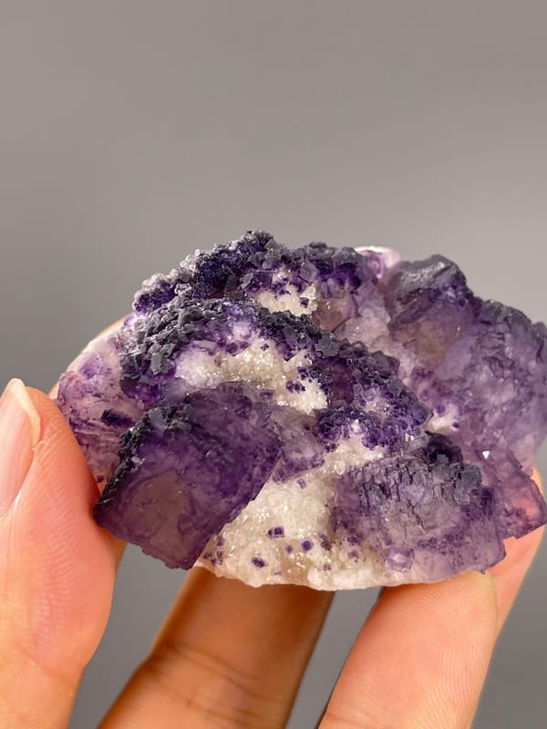 Calcite from Guizhou, China: close view of purple surfaces with small pits.