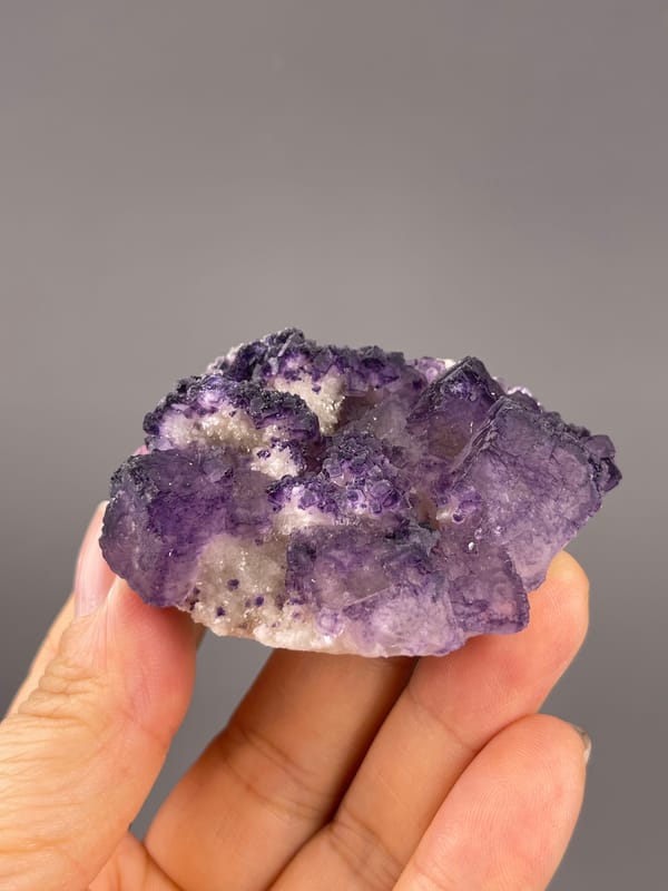 Calcite from Guizhou, China: horizontal whole view showing alternating purple and white areas.