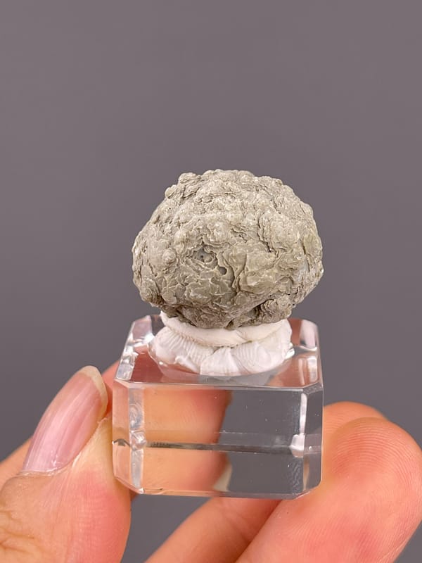 Calcite from Huanggangliang, Inner Mongolia, China: rounded pale green aggregate with folded layers.