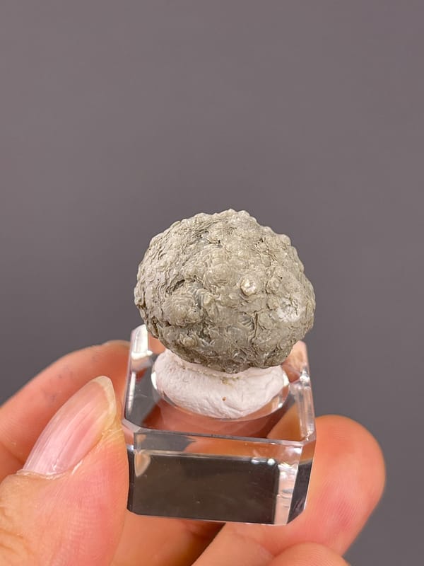 Calcite from Huanggangliang, Inner Mongolia, China: pale green layered aggregate seen from the back.