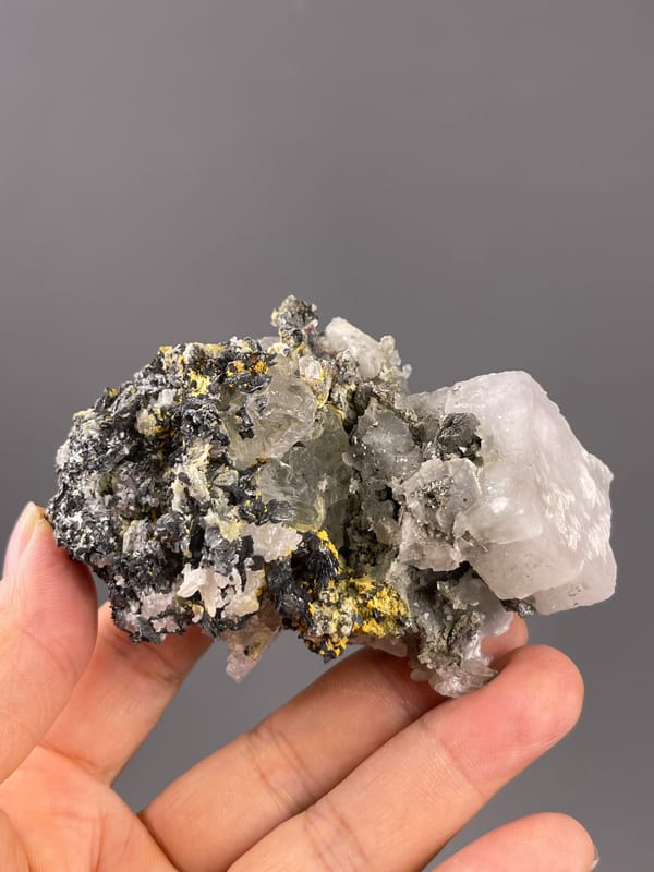 Calcite from Inner Mongolia, China: horizontal view showing the contrasting pale end and dark mass.