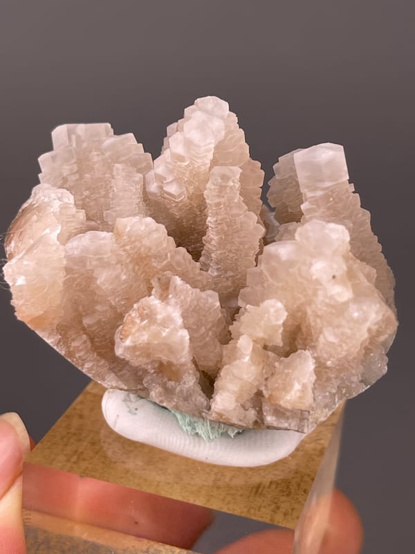 Peach stacked calcite crystals visible on calcite specimen from Longyan, Fujian, China