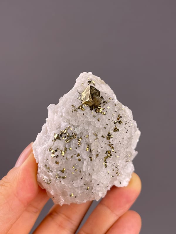 Calcite from Longyan, Fujian, China: front view showing a prominent angular metallic crystal.