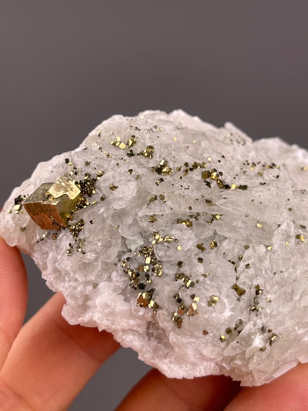 Calcite from Longyan, Fujian, China: close oblique view of metallic crystals on pale growths.