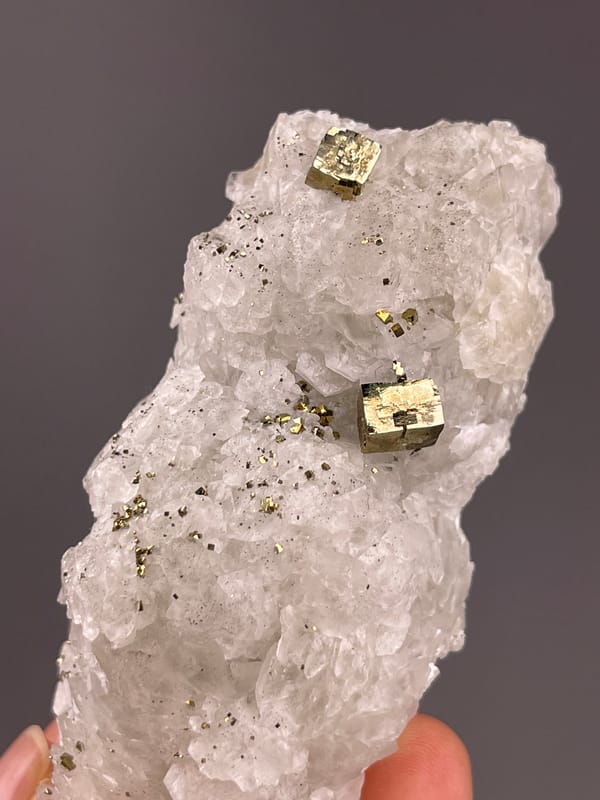 Calcite from Longyan, Fujian, China: tilted view of bright metallic faces near the upper half.