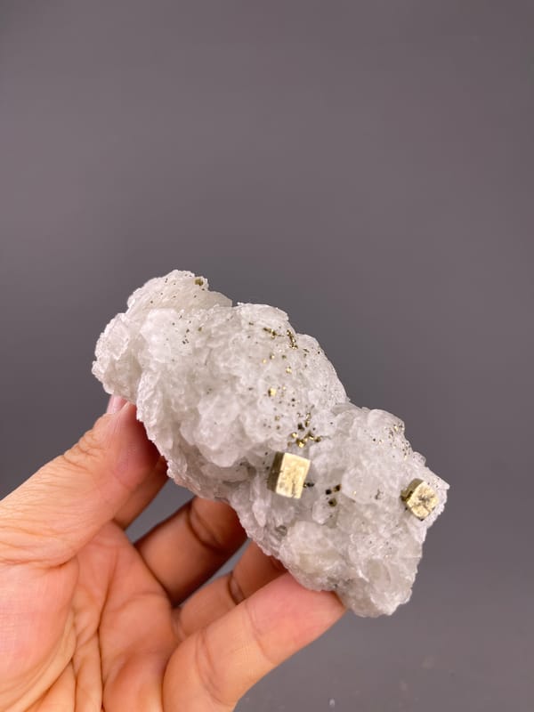 Calcite from Longyan, Fujian, China: horizontal full view with brassy crystals at one end.